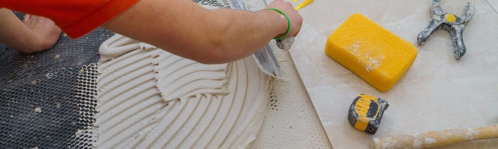 Applying new tiles on bathroom floor tile installation for house building