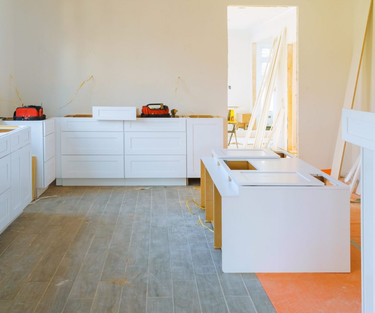 Installation modern kitchen cabinet closeup of furniture details.